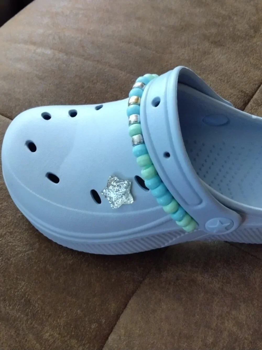 Embellished blue plastic shoes for kids with matching hair band.